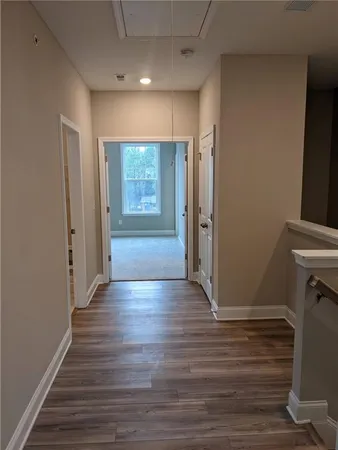an empty room with wooden floor and a window