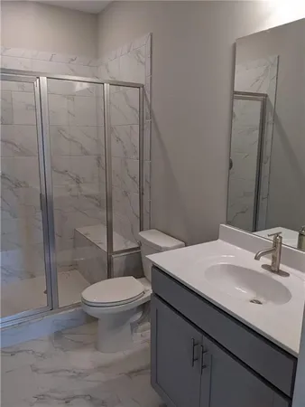 a bathroom with a sink toilet and shower