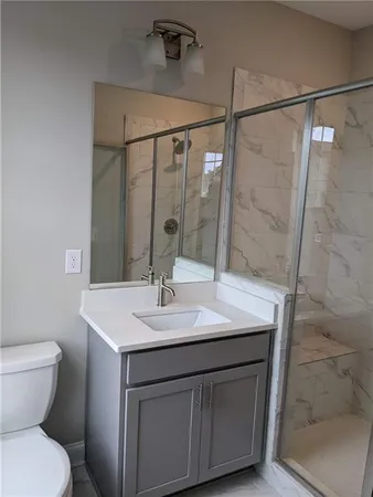 a bathroom with a sink toilet and shower