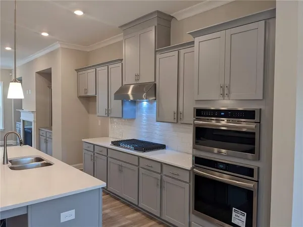 a kitchen with cabinets and appliances