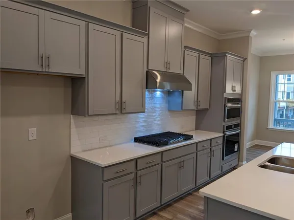 a kitchen with cabinets and a stove top oven