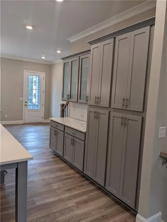 a kitchen with sink cabinets and wooden floor