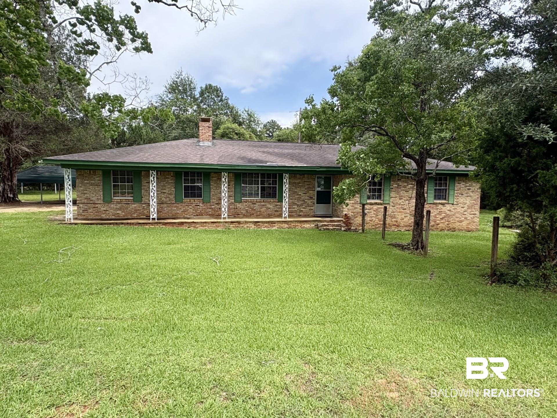 230 Dee Watts Road Bay Minette, AL 36507 - Photo 2 of 2 Brick exterior featuring a covered front porch with decorative white columns