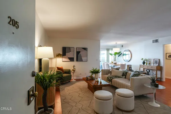 a living room with furniture and a lamp