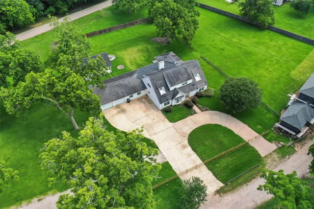 an aerial view of a house with a yard and outdoor seating
