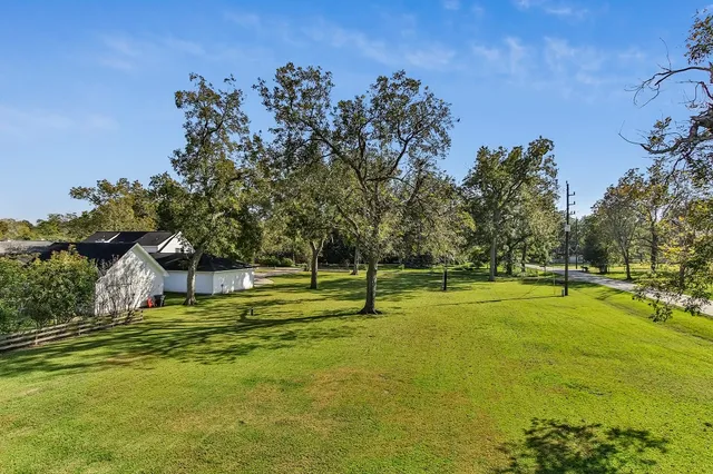 a swimming pool with outdoor seating and yard