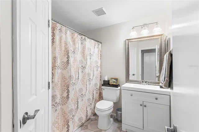 a bathroom with a toilet a sink and a mirror