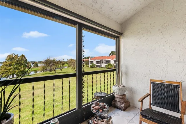 a view of a room with furniture and floor to ceiling window