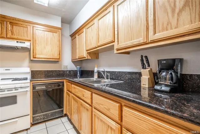 a kitchen with stainless steel appliances granite countertop a sink and cabinets