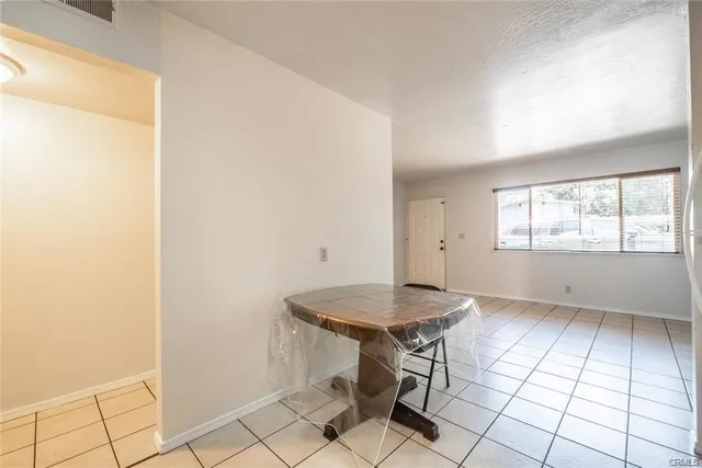 a view of a room that has a table and chair in it