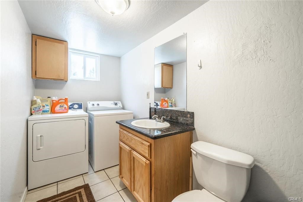 609 Rancheria Drive Chico, CA 95926 - Photo 16 of 60 a bathroom with a granite countertop toilet sink and mirror
