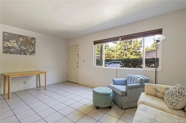 a view of kitchen with furniture and refrigerator