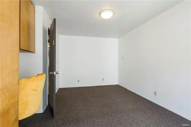 a bathroom with a granite countertop sink toilet a mirror and shower