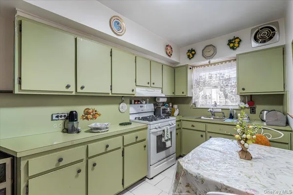 a kitchen with a sink a stove and cabinets