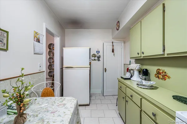 a kitchen with a refrigerator and cabinets