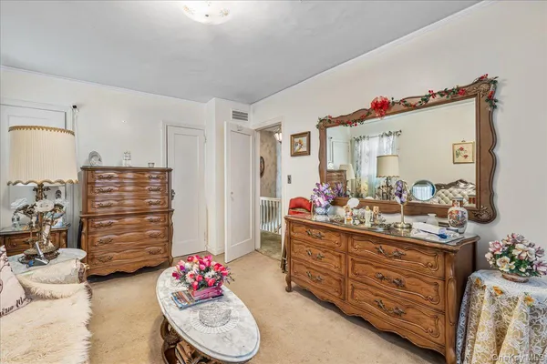 a bedroom with a bed and a mirror
