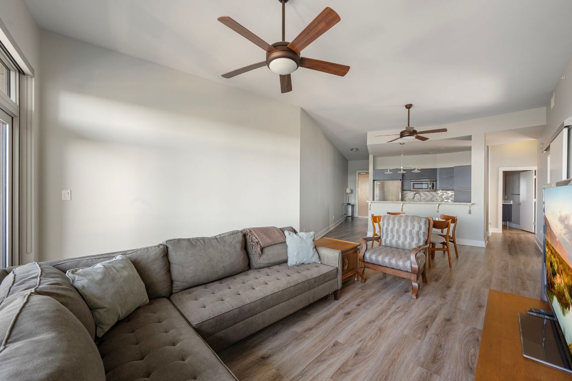 603 Davis Street, Unit 2009 Austin, TX 78701 - Photo 14 of 37 a living room with furniture and a wooden floor