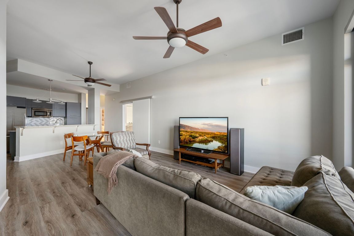 603 Davis Street, Unit 2009 Austin, TX 78701 - Photo 15 of 37 a living room with furniture and a flat screen tv