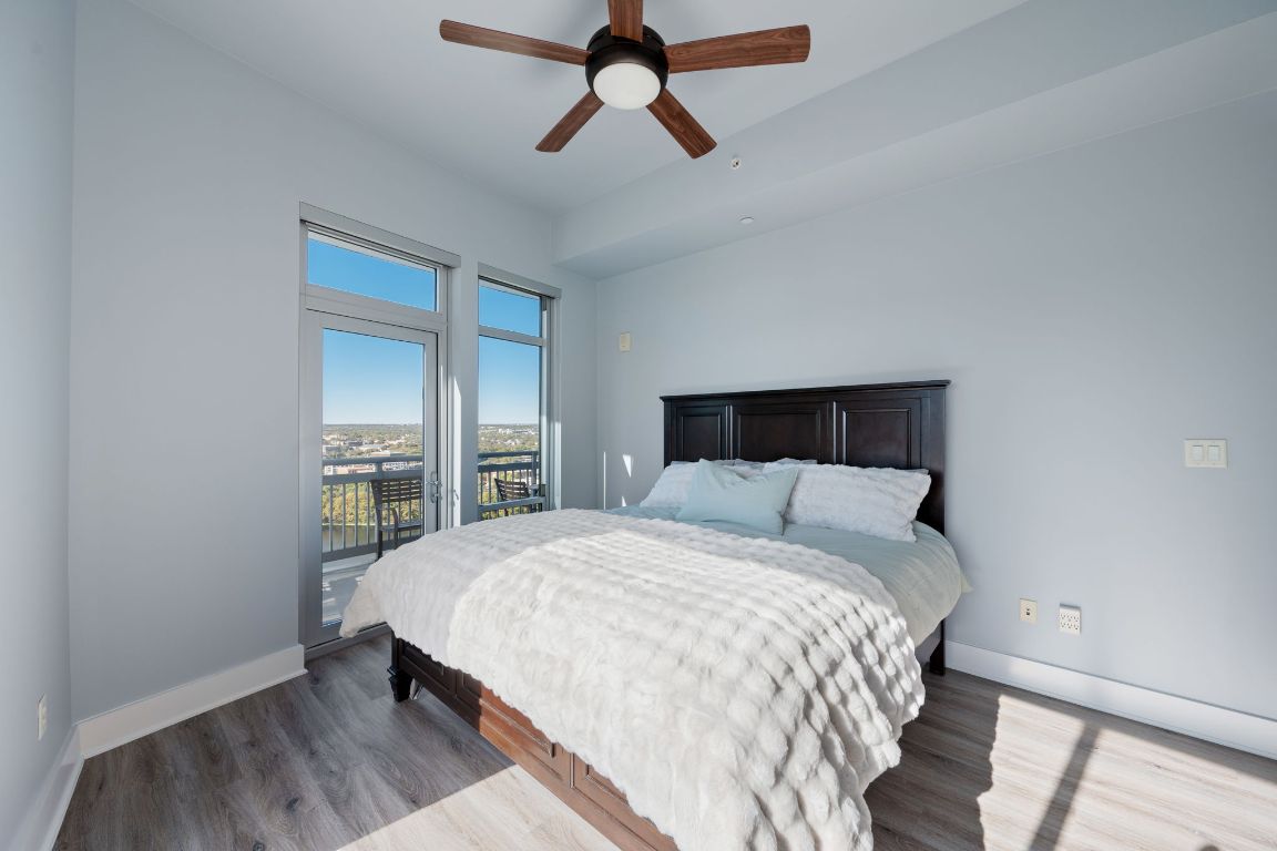 603 Davis Street, Unit 2009 Austin, TX 78701 - Photo 18 of 37 a bedroom with a bed and wooden floor