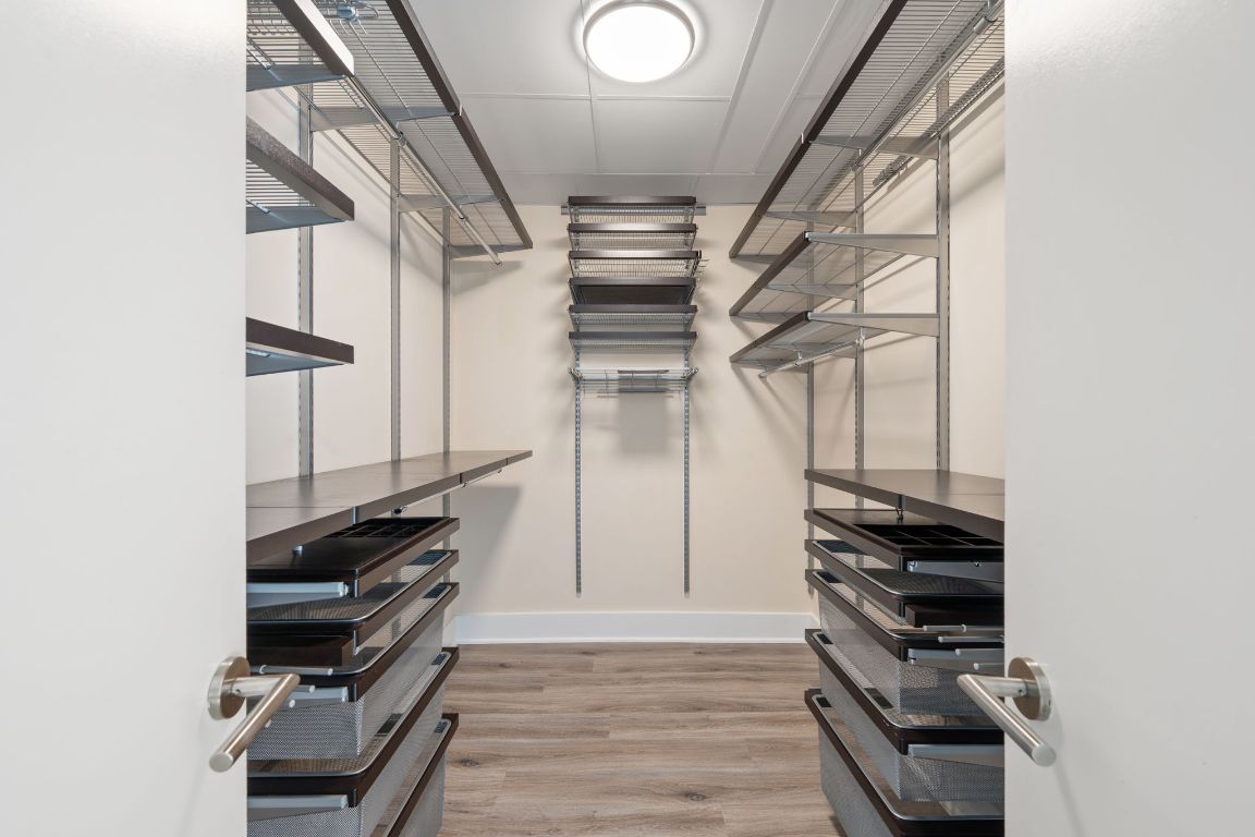 603 Davis Street, Unit 2009 Austin, TX 78701 - Photo 22 of 37 a view of walk in closet with clothes and shoes