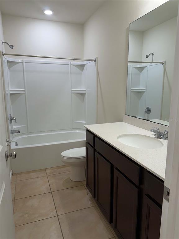 7363 Catania Loop Clermont, FL 34714 - Photo 11 of 12 a bathroom with a sink a toilet and shower