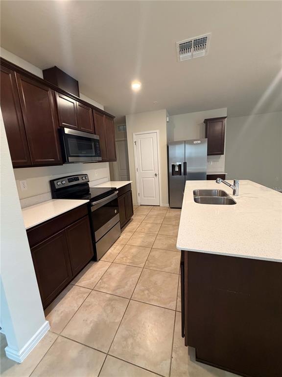 7363 Catania Loop Clermont, FL 34714 - Photo 3 of 12 a kitchen with a sink appliances and cabinets