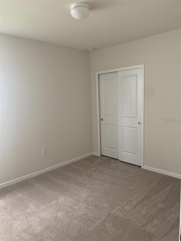 7363 Catania Loop Clermont, FL 34714 - Photo 6 of 12 an empty room with closet area