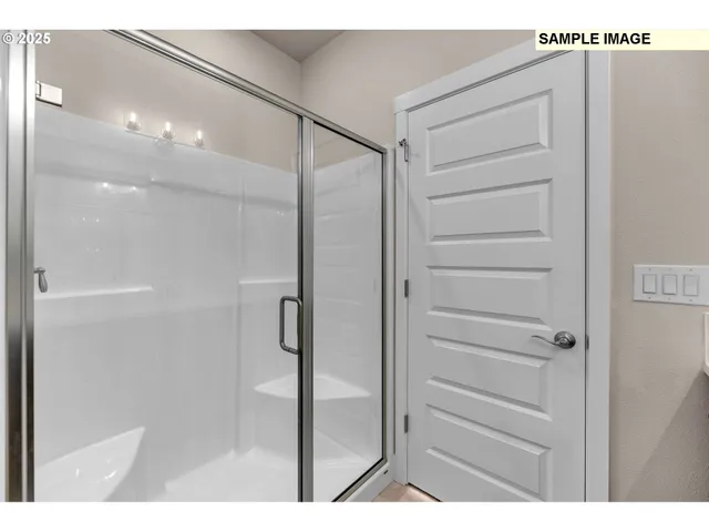 a bathroom with a shower and a glass door