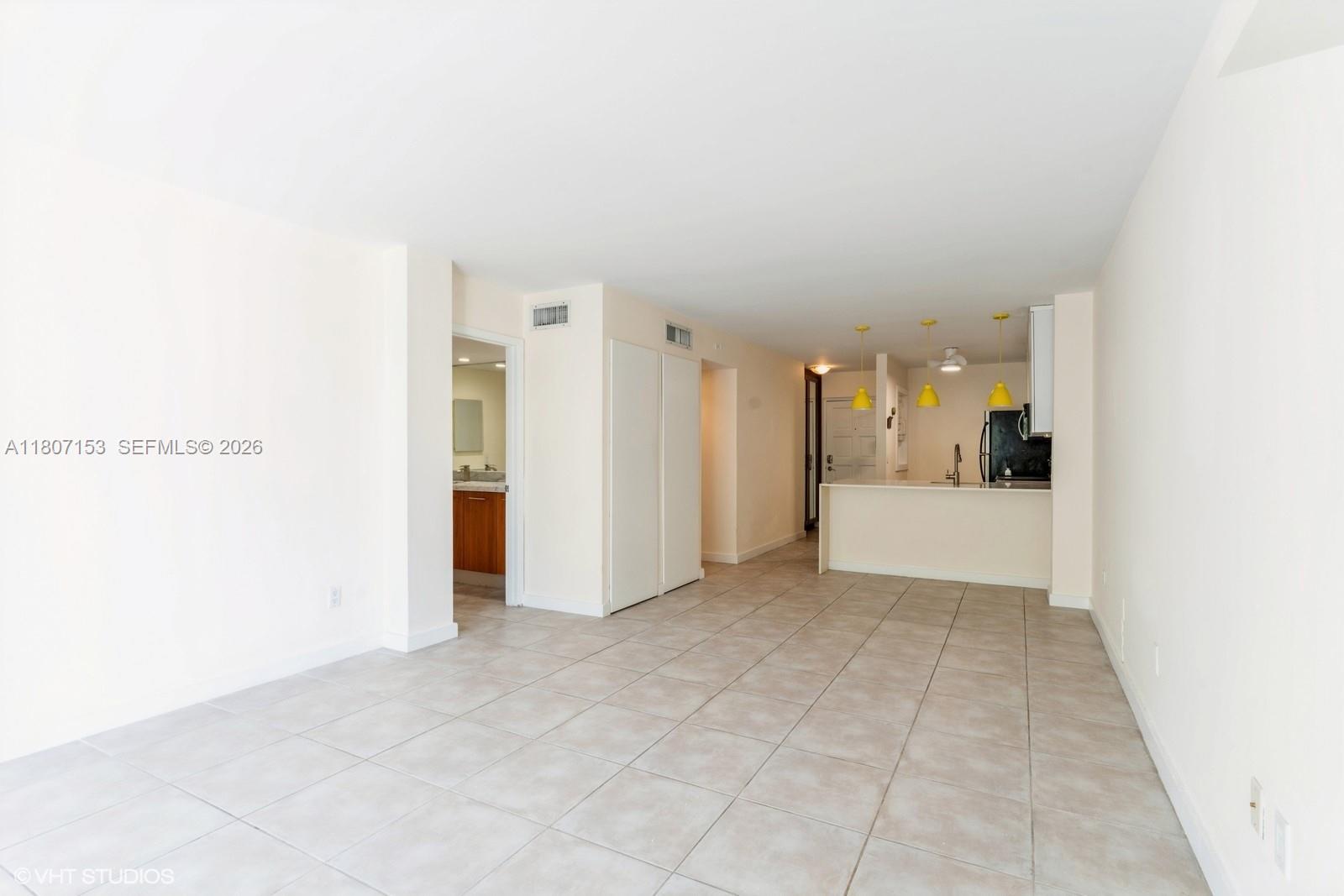 750 Northeast 64th Street, Unit B308 Miami, FL 33138 - Photo 18 of 25 a view of a big room with closet and windows