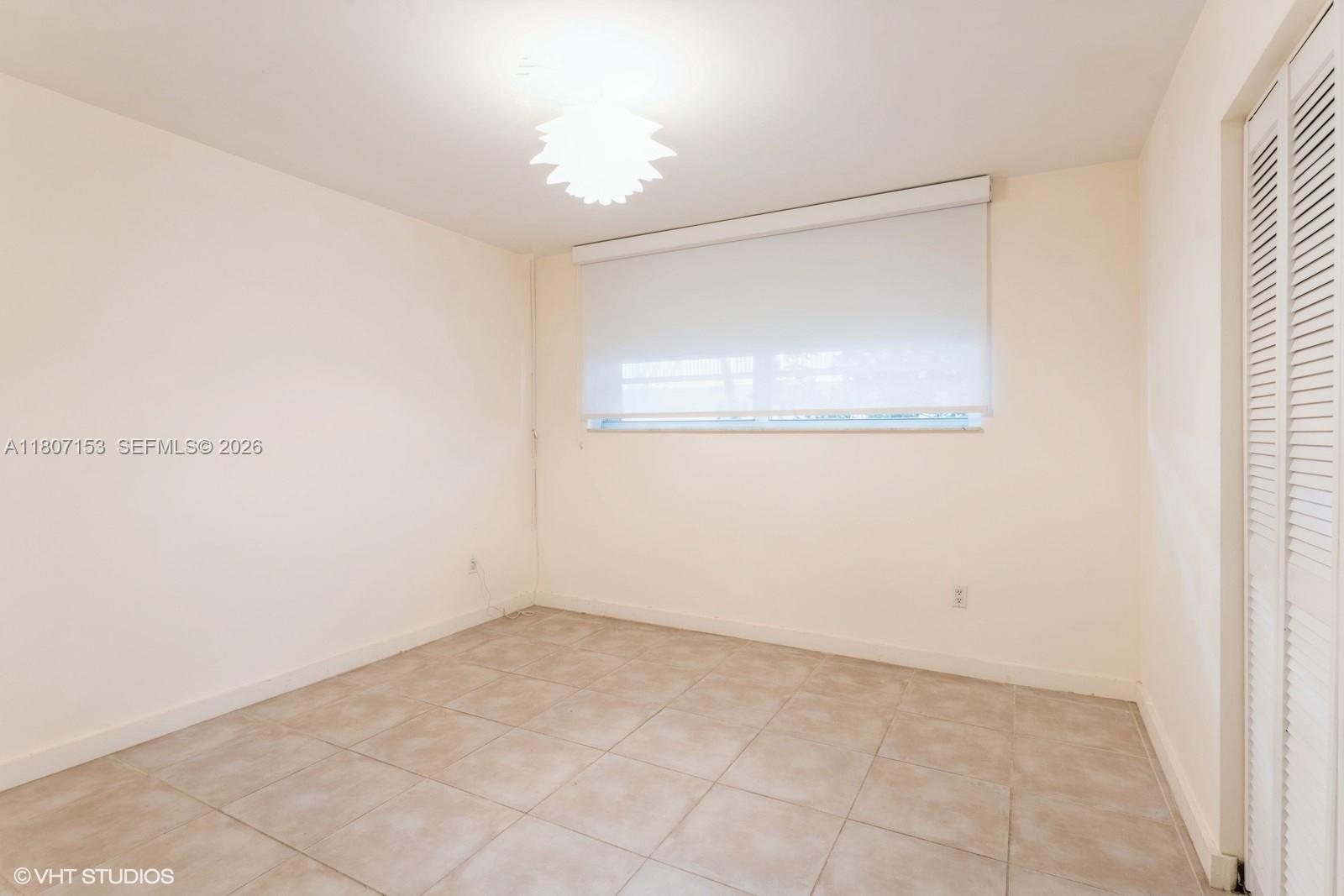 750 Northeast 64th Street, Unit B308 Miami, FL 33138 - Photo 19 of 25 an empty room with a window
