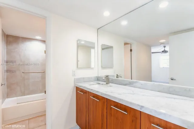 a bathroom with a sink double vanity shower and a bathtub