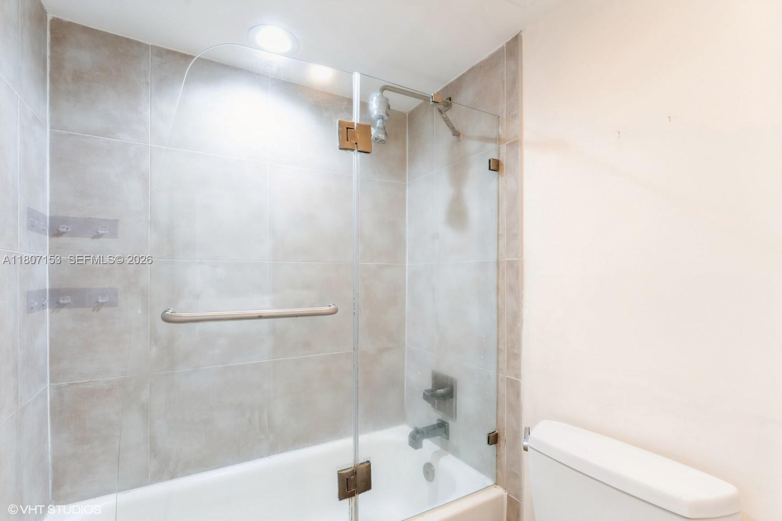 750 Northeast 64th Street, Unit B308 Miami, FL 33138 - Photo 24 of 25 a bathroom with a shower and a toilet