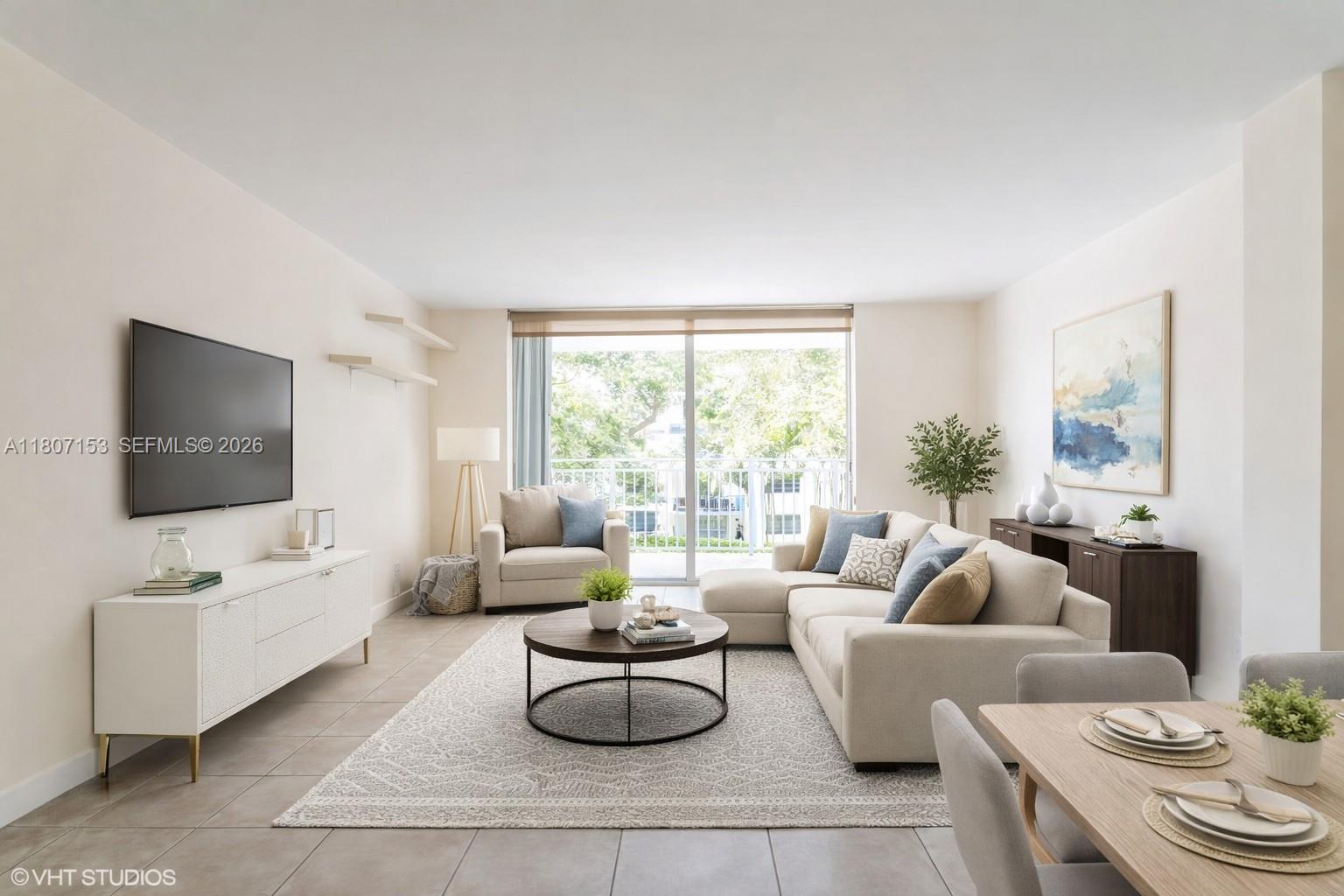 750 Northeast 64th Street, Unit B308 Miami, FL 33138 - Photo 5 of 25 a living room with furniture and a flat screen tv