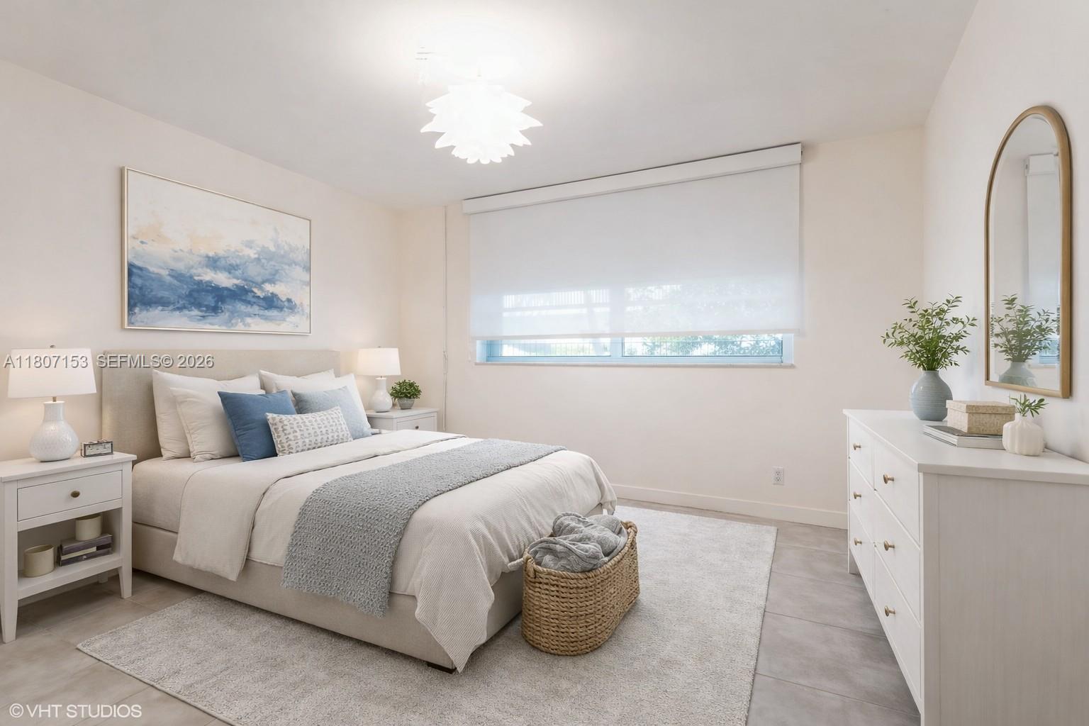 750 Northeast 64th Street, Unit B308 Miami, FL 33138 - Photo 6 of 25 a bedroom with a bed and a chandelier