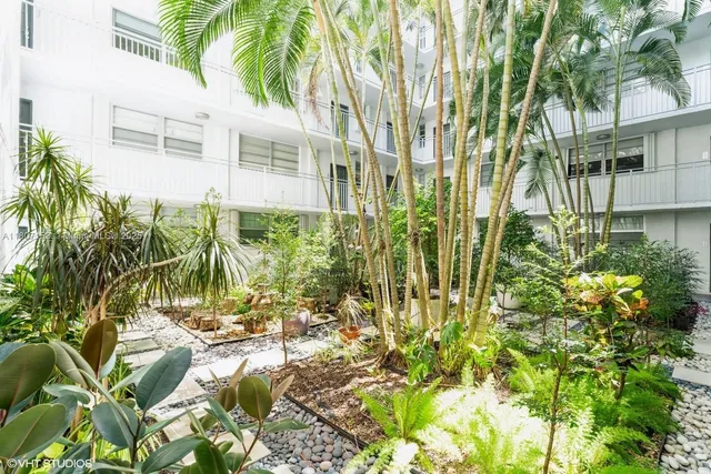 a view of a garden with a house