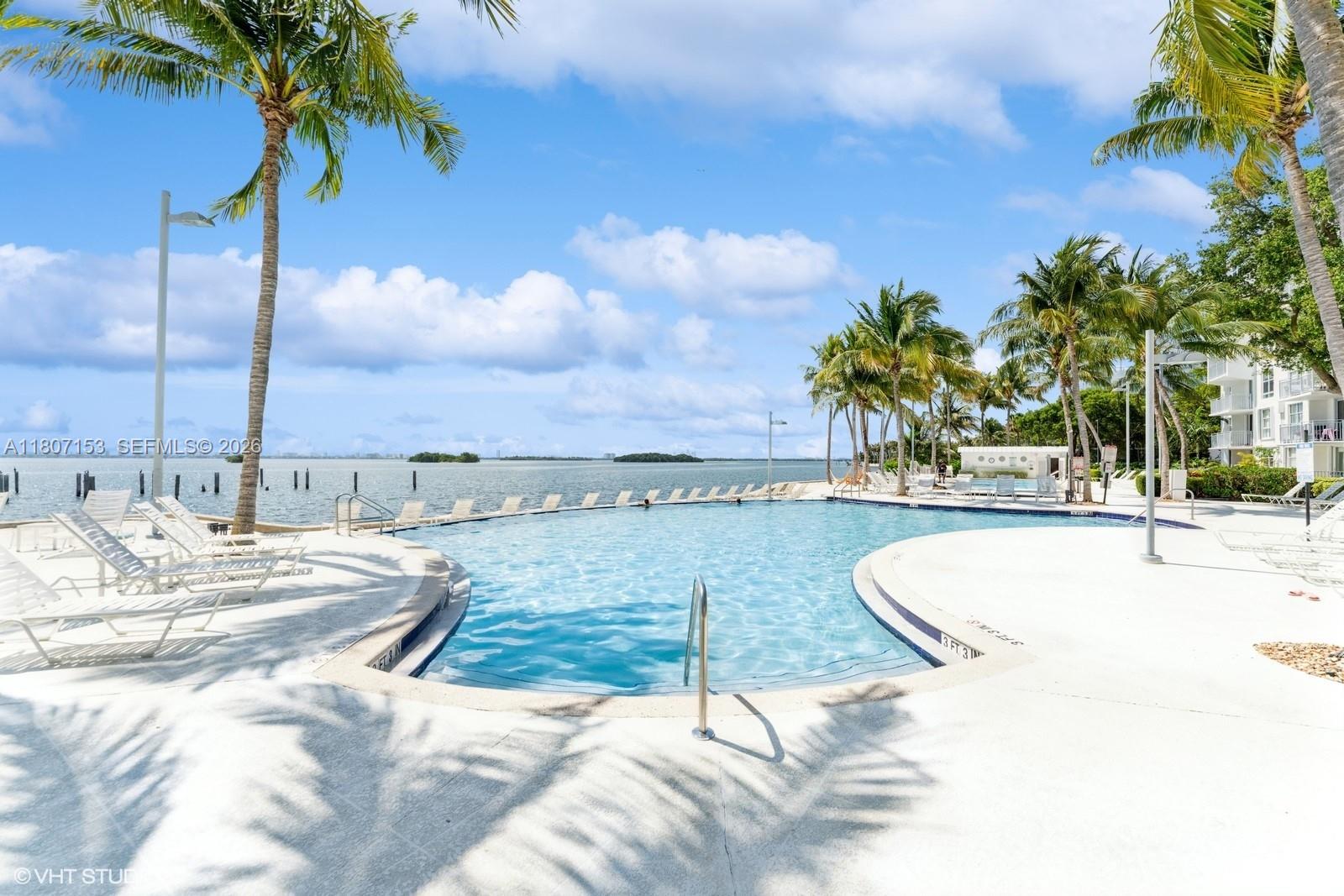 750 Northeast 64th Street, Unit B308 Miami, FL 33138 - Photo 10 of 25 a view of a swimming pool with a lounge chairs