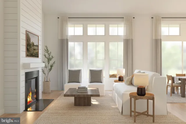 a living room with furniture fireplace and a large window