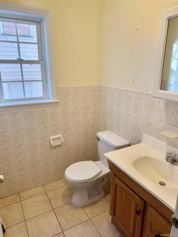 a bathroom with a sink a toilet and a mirror