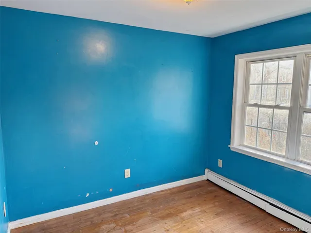a view of a livingroom with wooden floor and a window
