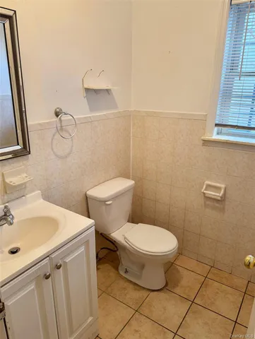 a bathroom with a sink toilet and a mirror