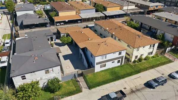 an aerial view of multiple houses with yard