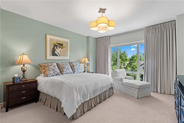 a spacious bedroom with a bed and a window