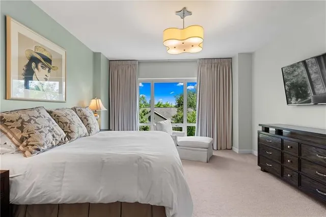 a bedroom with a large bed and a window