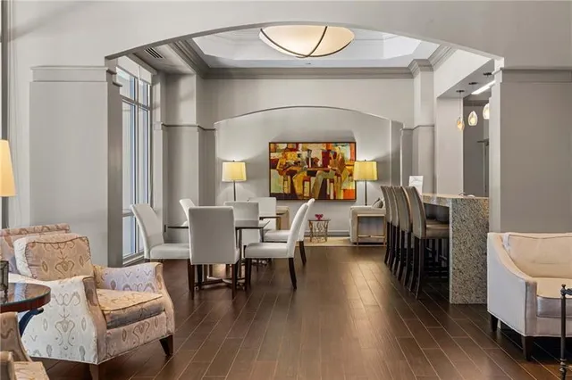 a living room with furniture a fireplace and a chandelier