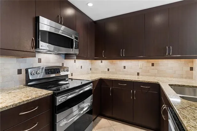 a kitchen with a sink and a stove top oven
