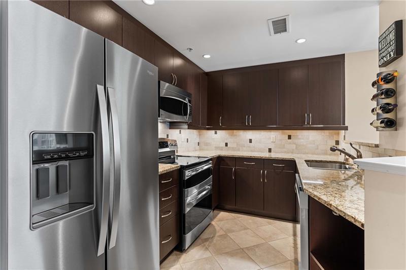 3475 Oak Valley Road Northeast, Unit 470 Atlanta, GA 30326 - Photo 9 of 34 a kitchen with stainless steel appliances granite countertop a sink stove and refrigerator