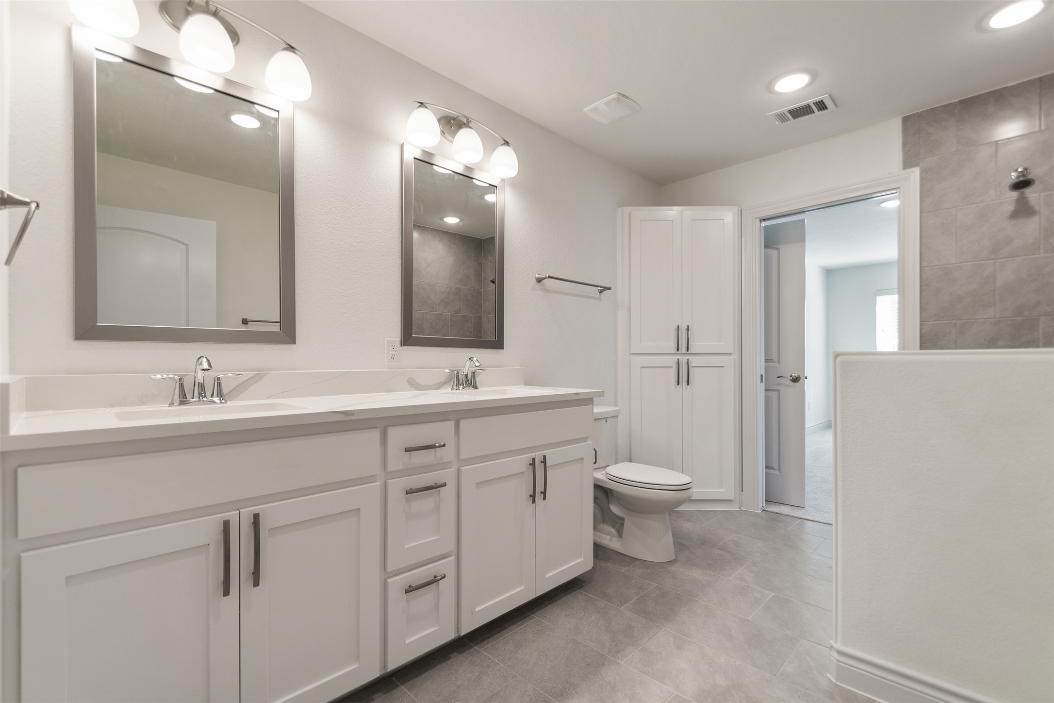 2105 Tiger Trail, Unit 103 Round Rock, TX 78664 - Photo 34 of 38 Full bath, located on the 2nd floor with double vanity, tub/shower combination, light tile patterned flooring and recessed lighting