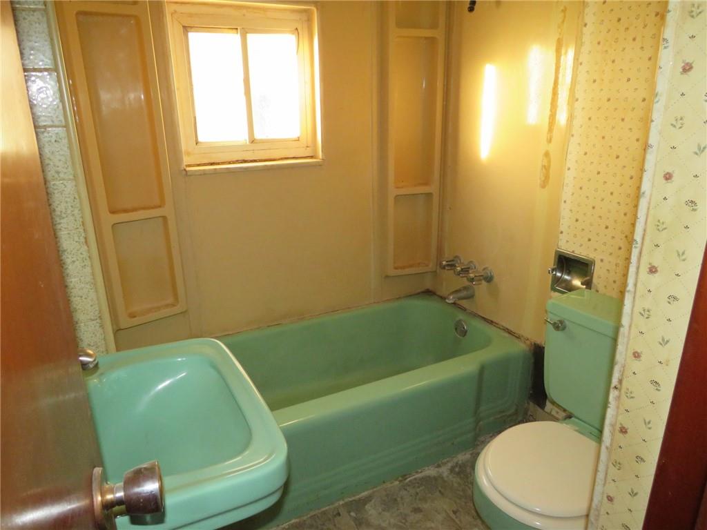 1252 Brinton Road Pittsburgh, PA 15221 - Photo 22 of 35 a bathroom with a sink and a mirror