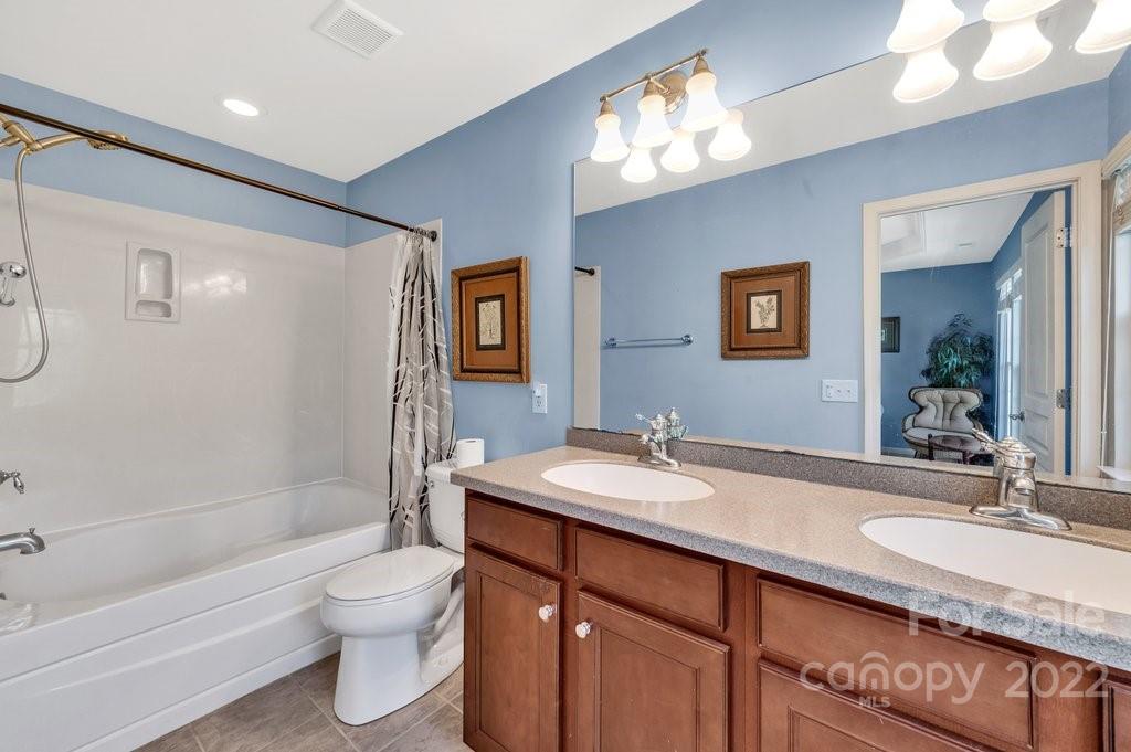 584 6th Baxter Crossing Fort Mill, SC 29708 - Photo 13 of 21 a bathroom with a granite countertop sink toilet and shower