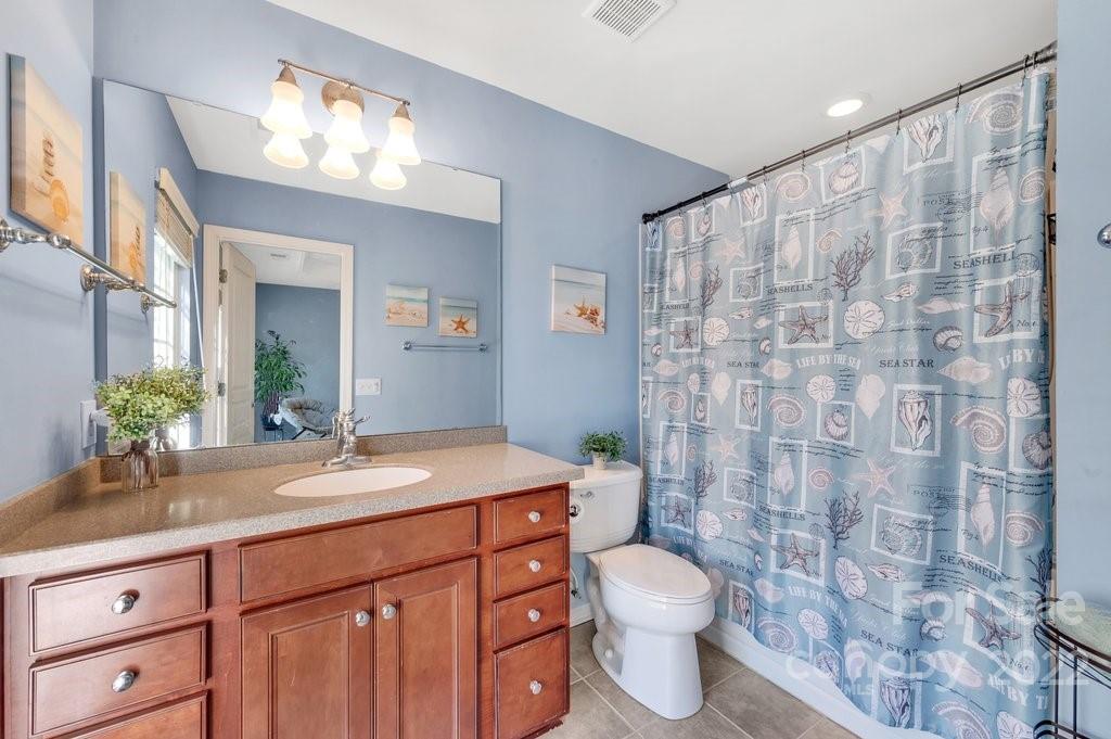 584 6th Baxter Crossing Fort Mill, SC 29708 - Photo 16 of 21 a bathroom with a granite countertop sink a toilet and a mirror